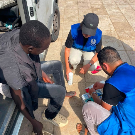 Aid workers assists an injured migrants on the Spain–Morocco border in Ceuta